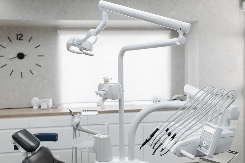 An empty dental surgery with the chair and light