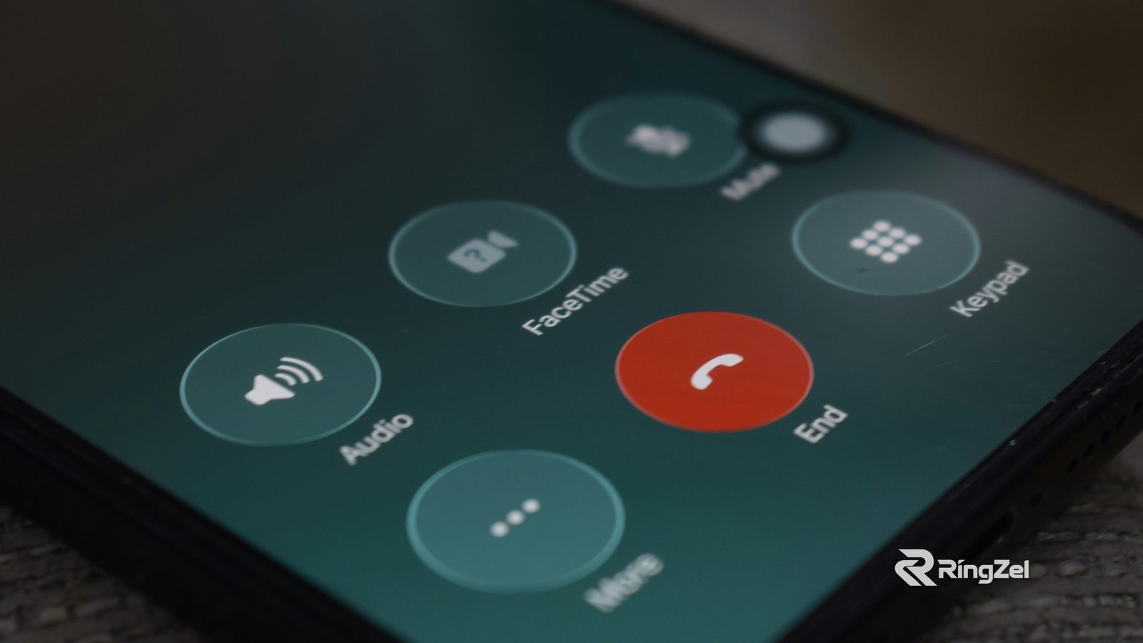 Close-up of a smartphone during a call, with the red End button beside Audio, FaceTime, Keypad and More.