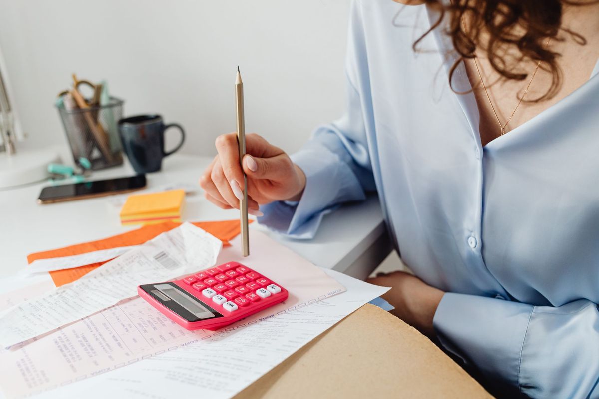 Working through receipts with a calculator at a desk
