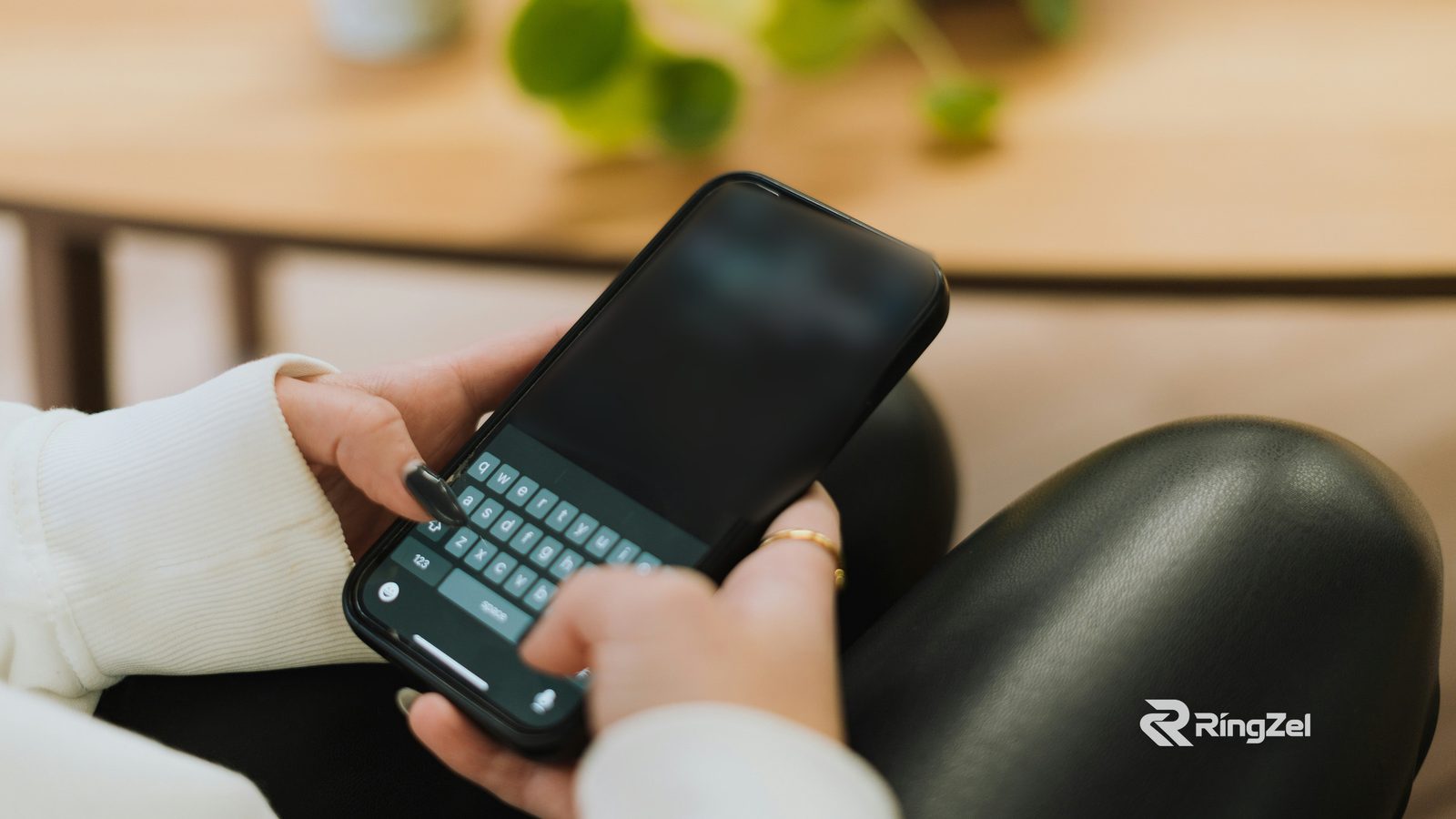 Close-up of someone typing a text message on their phone.