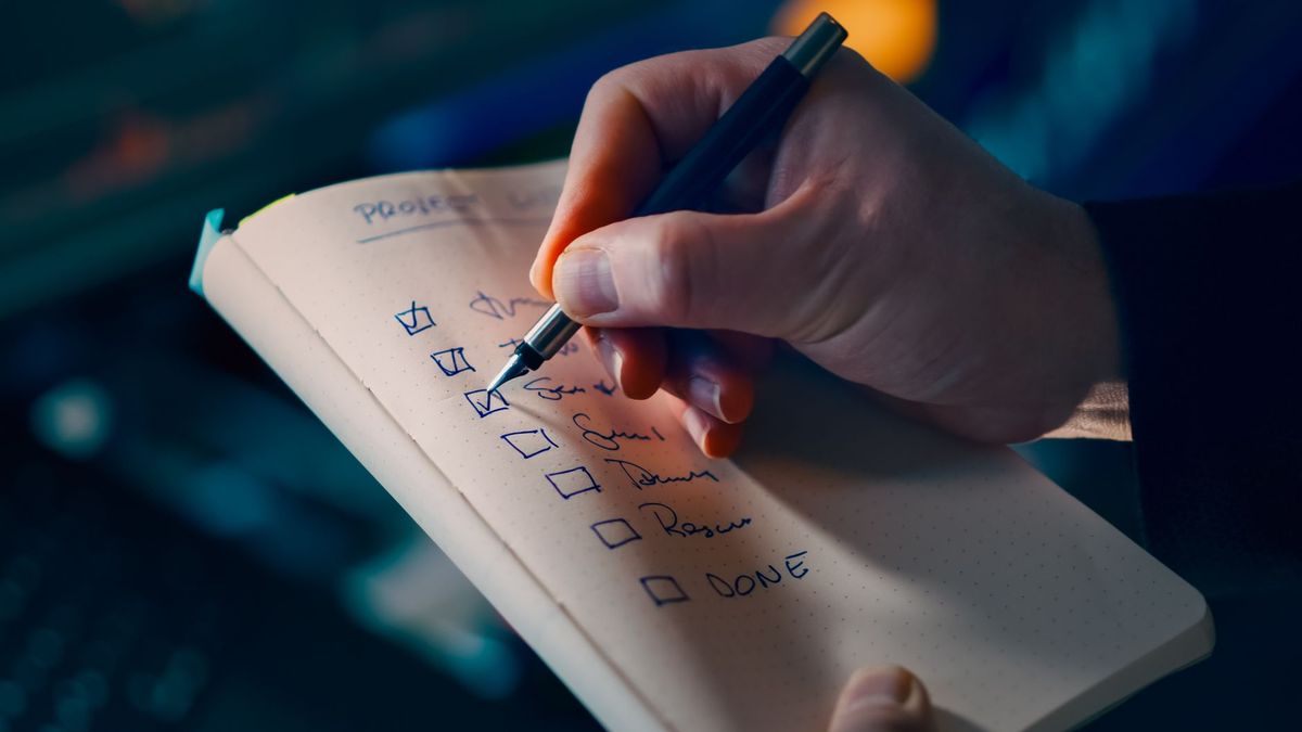 Ticking items off a checklist in a notebook