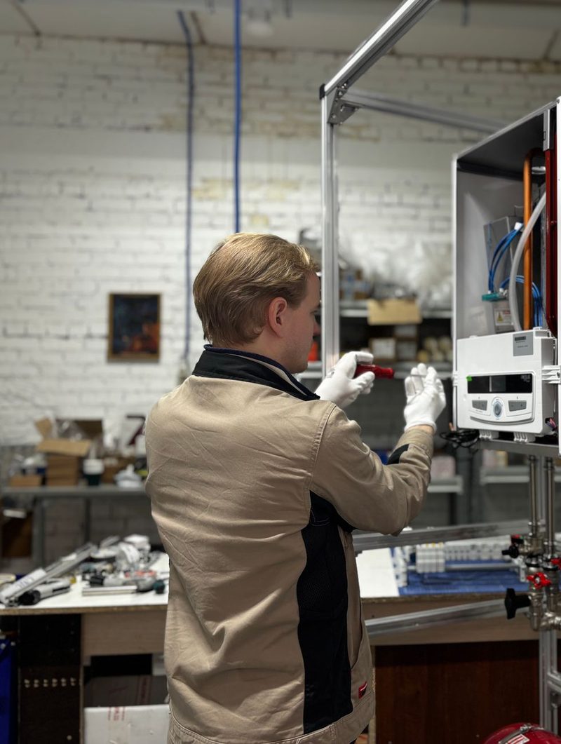 An engineer working on a boiler in a plant room